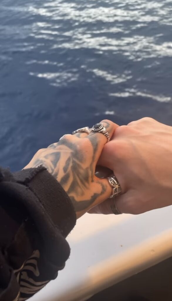 holding hands by the ocean