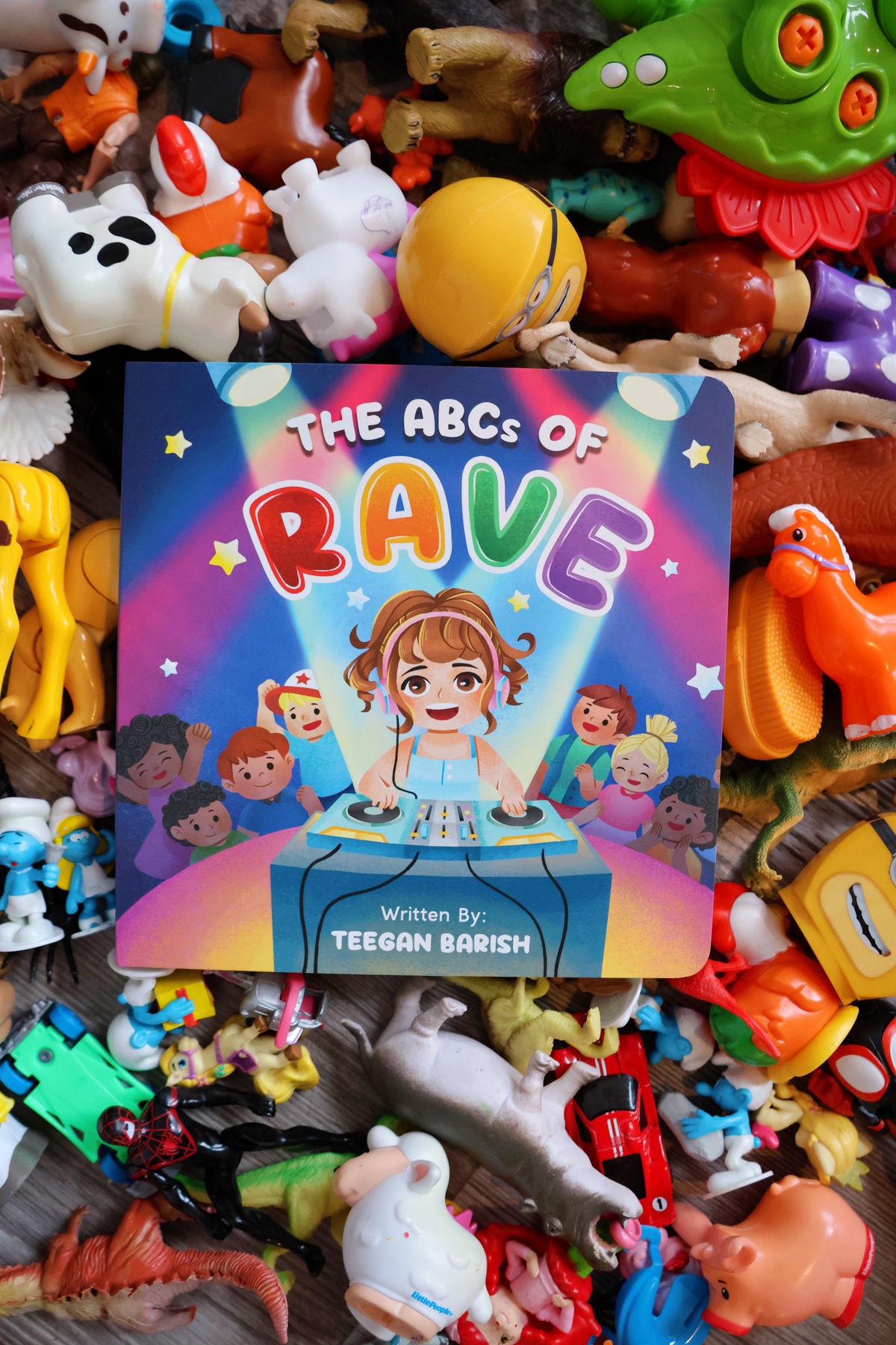 The ABC's of Rave book cover over pile of toys