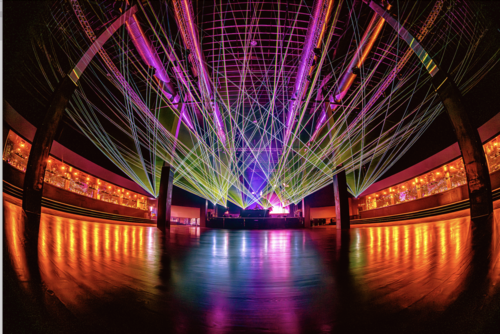 Vibrant laser light show illuminating the dance floor at SILO Dallas, a futuristic nightclub located in the Design District, showcasing its advanced lighting and spacious layout