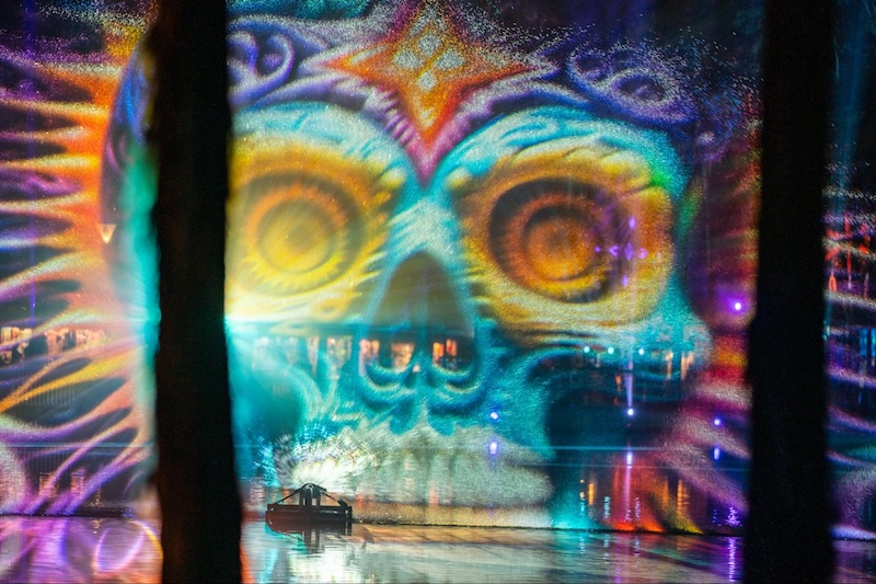 candy skull visuals appearing amongst the trees of Spirit Lake at Hulaween Music Festival