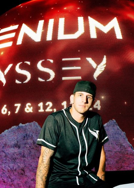 ILLENIUM seated in front of Sphere Las Vegas, with the venue’s LED exterior glowing behind him ahead of his ODYSSEY shows.